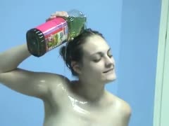 A filthy skank covers her body with vegetable oil.